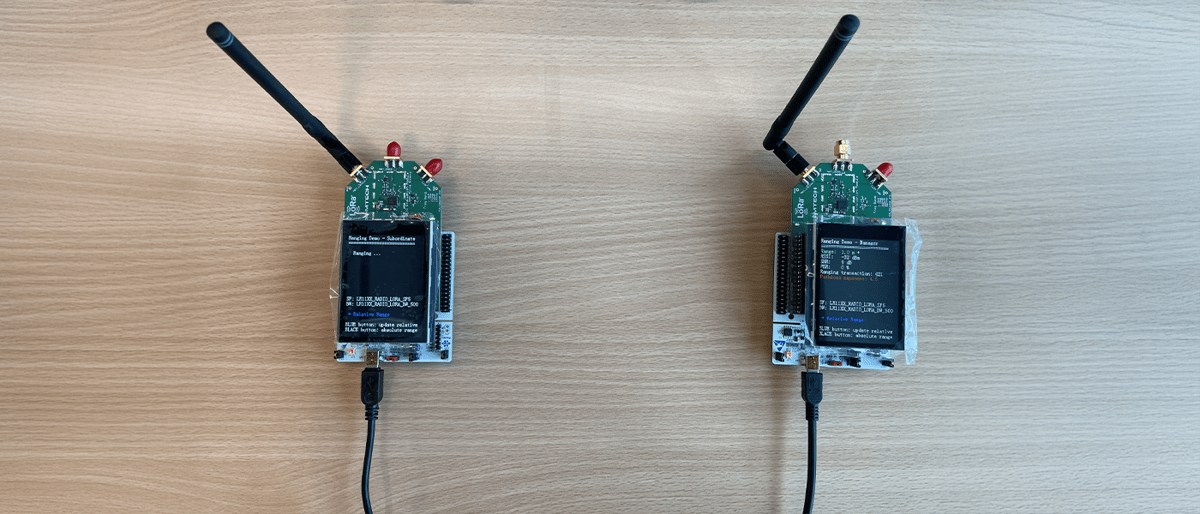 Semtech LoRa-enabled walkie-talkie devices featuring Murata 2GT module with LR1121 chip, showing both sub-GHz model with large antenna and 2.4 GHz model with compact antenna, demonstrating real-time voice communication capabilities at Electronica India 2025