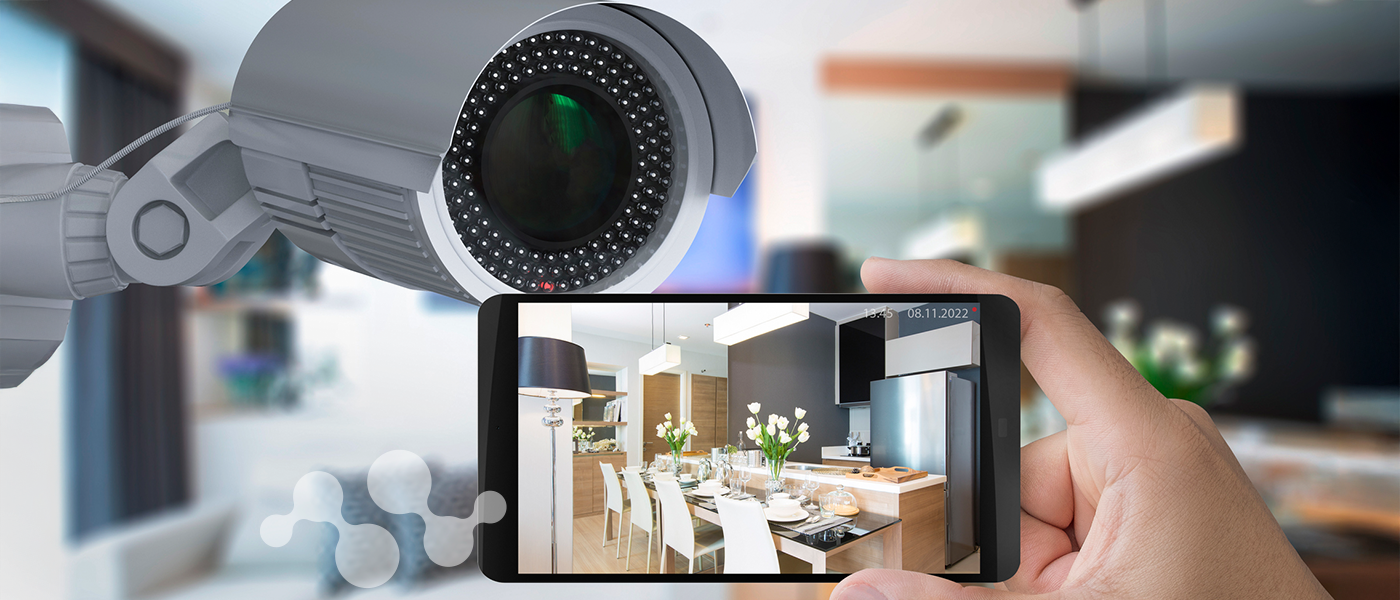 Security camera transmitting live video feed to smartphone showing dining room surveillance via Semtech LR2021 wireless technology