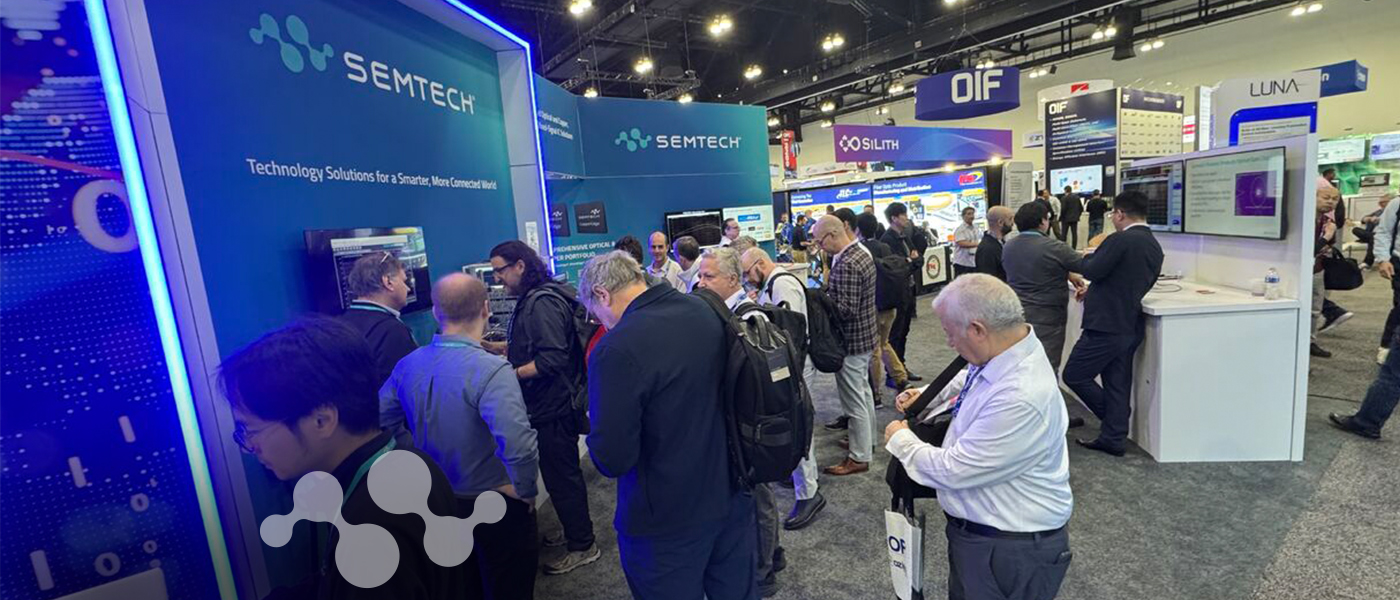 Attendees crowd the Semtech booth at OFC 2026 in Los Angeles, with the Semtech logo and "Technology Solutions for a Smarter, More Connected World" tagline displayed on teal booth panels.